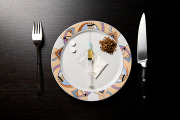 drugs on a plate are prepared for consumption