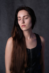 Naklejka premium studio portrait of a girl of Slavic appearance with closed eyes. on a black background.