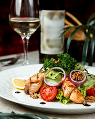 mixed salad with herbs and fried fish