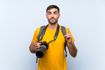 Young photographer man pointing with the index finger a great idea