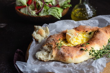 Khachapuri, traditional Georgian cuisine. Adjarian open bread pie with cheese and egg yolk. Caucasian kitchen. 