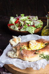 Khachapuri, traditional Georgian cuisine. Adjarian open bread pie with cheese and egg yolk. Caucasian kitchen. 