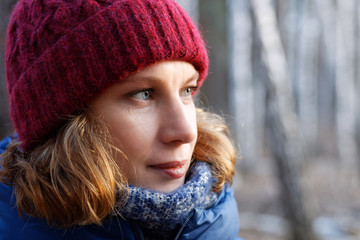Closeup outdoor portrait of woman walking in the forest against blurred background