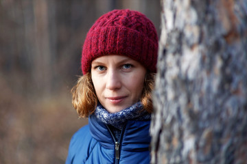 Outdoor portrait of woman walking in the forest against blurred background