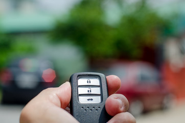 Car smart key is an electronic access and authorization system, Hand holding smart key of car.