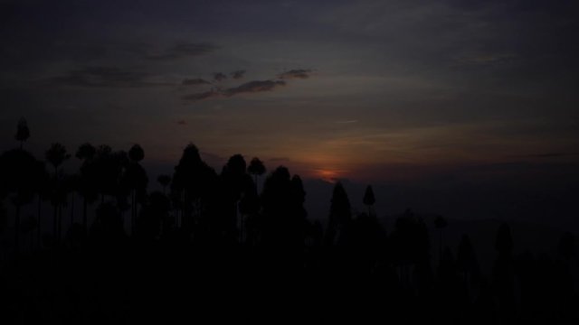 Morning timelapse of the sun rising as seen from Antu Danda, Illam, Nepal that receives the first sun-rise in Nepal. Wide Shot.