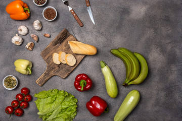 Collection of different fresh raw vegetables on a grey background. Top view