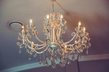 The lamp in the beautiful room .Brass chandelier with crystal. Chandelier ceiling lights