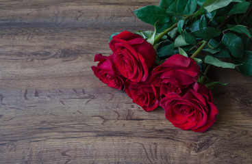 bouquet with red roses on a wooden background