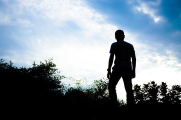 silhouette of a man looking to the front in a beautiful sky background