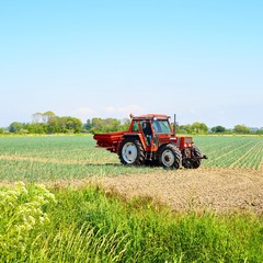 Red tractor working on a field in the Netherlands © Alex Stemmer