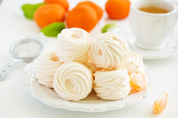 Delicious homemade marshmallows and oranges with spices.