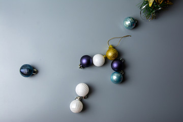 multi-colored Christmas toys on a gray background