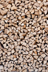 Gigantic woodpile in the courtyard of a village house. Harvesting firewood from pine and birch for the winter for the stove. Heating season. Alternative power supply. Village concept