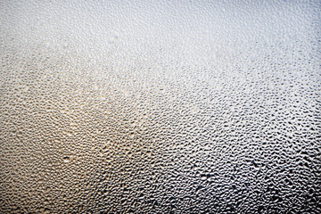A foggy window close-up. Water droplets on a glass. Abstract background.