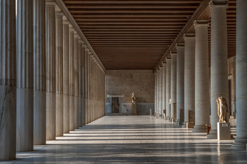 Passage with marble Ionic columns inside stoa of Attalos, ancient agora of Athens before sunset