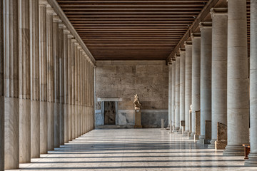 Passage with marble ionic columns inside stoa of Attalos, ancient agora of Athens before sunset