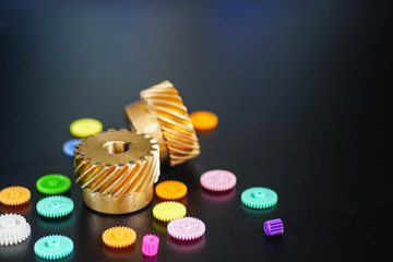  Helical Gears Brass and Plastic gears On a black background, the concept of work movement movement