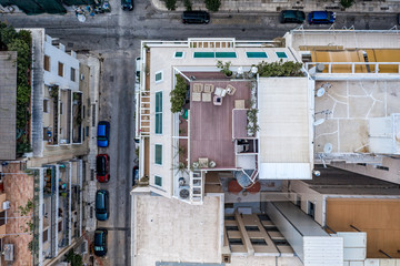 Fototapeta na wymiar Overhead aerial drone shot of roof patio in west Athens in sunny summer