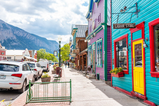 Crested Butte, USA - June 21, 2019: Colorado colorful vivid village houses stores shopping downtown in summer with vintage mountain architecture and cars on street