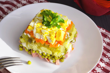 Home cuisine Olivier salad, closeup photo. To the festive table.