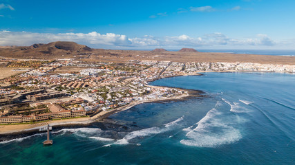 aerial view of waves crashing on the bay of corralejo, fuerteventura