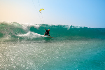 The kite surfer rides the waves of the Atlantic Ocean