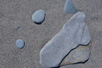 Silvery Rocks , Pebbles and Stones on Sandy Beach
