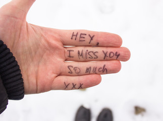 sign of love I Miss You on the hand of the man on a background of the river. Valentine's Day postcard. Love concept for mother's or Valentine day with space for text