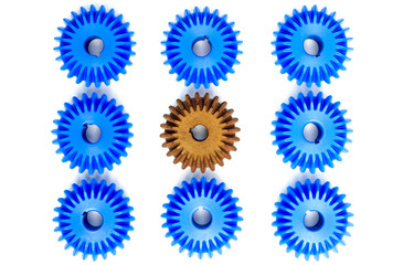 The brown Bevel Gears stand out from many blue crowds on a white background. Leadership,...