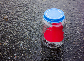 heart in a glass jar. fragile. background stones.Valentine's Day postcard. Love concept for mother's day with space for text