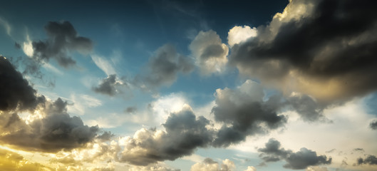Fototapeta premium Dark clouds and bright sun at sunset