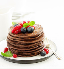 Chocolate pancakes with berries.