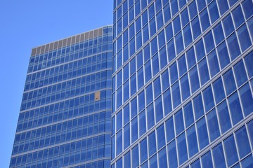 Fototapeta premium Abstract texture of blue glass modern building skyscrapers. Business background.