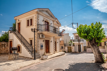 Fototapeta na wymiar Street with yellow houses in a Cretan village