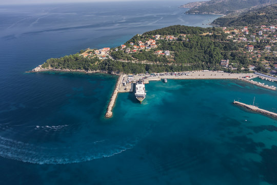 Aerial drone shot of cars embarking on big cruise ship at Poros town harbour of Kefalonia Island