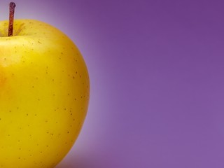 Yellow apple on a purple background with meta under the text