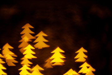 Yellow Lights Makes Christmas Pine Tree Shape Bokeh. Dark background concept with copy space