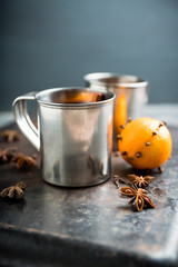 Mulled red wine in metal mug on the gray rustic background. Selective focus. Shallow depth of field.