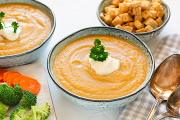 Cream vegetable soup broccoli, carrot, cauliflower with croutons. Vegetarian healthy food on light background