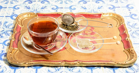 Top down shot of freshly brewed tea in traditional glasses on oriental tile table