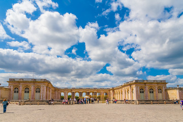 Fototapeta na wymiar Nice panoramic view in front of the entrance of the Grand Trianon Palace in Versailles. Influenced by Italian architecture, the palace has a single storey and a balustrade runs around the flat roof.