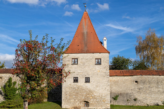 Autumn landscape with multicolored trees and city wall with tower in Berching, Bavaria