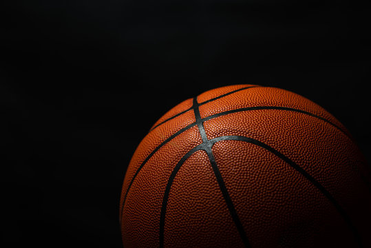 Basketball under the light with a black background