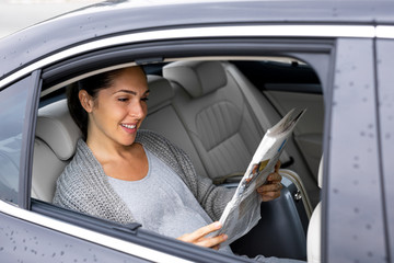 Beautiful young pregnant woman is driving in the car