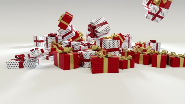 Red and white Christmas presents gift boxes wrapped with red and gold ribbons falling down on the ground on bright white background.