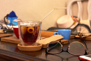 Glass with cold brew coffee on wooden table at cafe