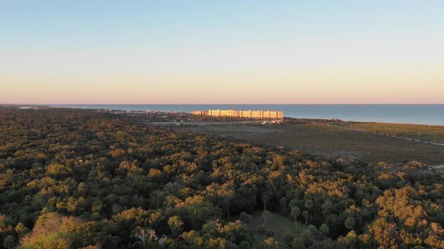 Aerial 4k Footage of Ormond Beach where swamp meet the beach, also showing condos on the beach