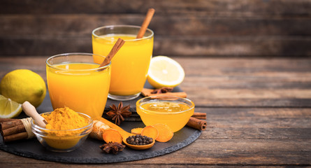 Healthy turmeric drink with honey, cinnamon, lemon and ginger