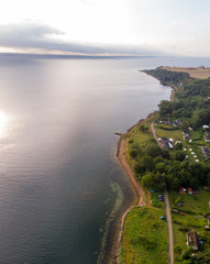 Aerial view of Husvik on Ven island in southern Sweden an early morning in summer during sunrise. 